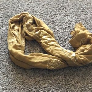 Gold scarf with white stitching